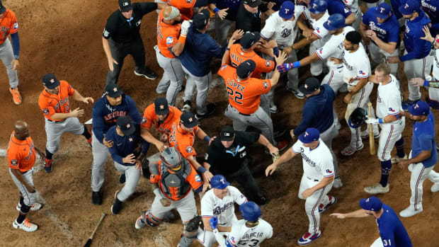 Players from Houston Astros and Texas Rangers clear the benches after Texas Rangers' Adolis Garcia was hit by a pitch thrown by Houston Astros relief pitcher Bryan Abreu during the eighth inning in Game 5 of the baseball American League Championship Series Friday, Oct. 20, 2023, in Arlington, Texas. (AP Photo/Godofredo A. Vásquez)   